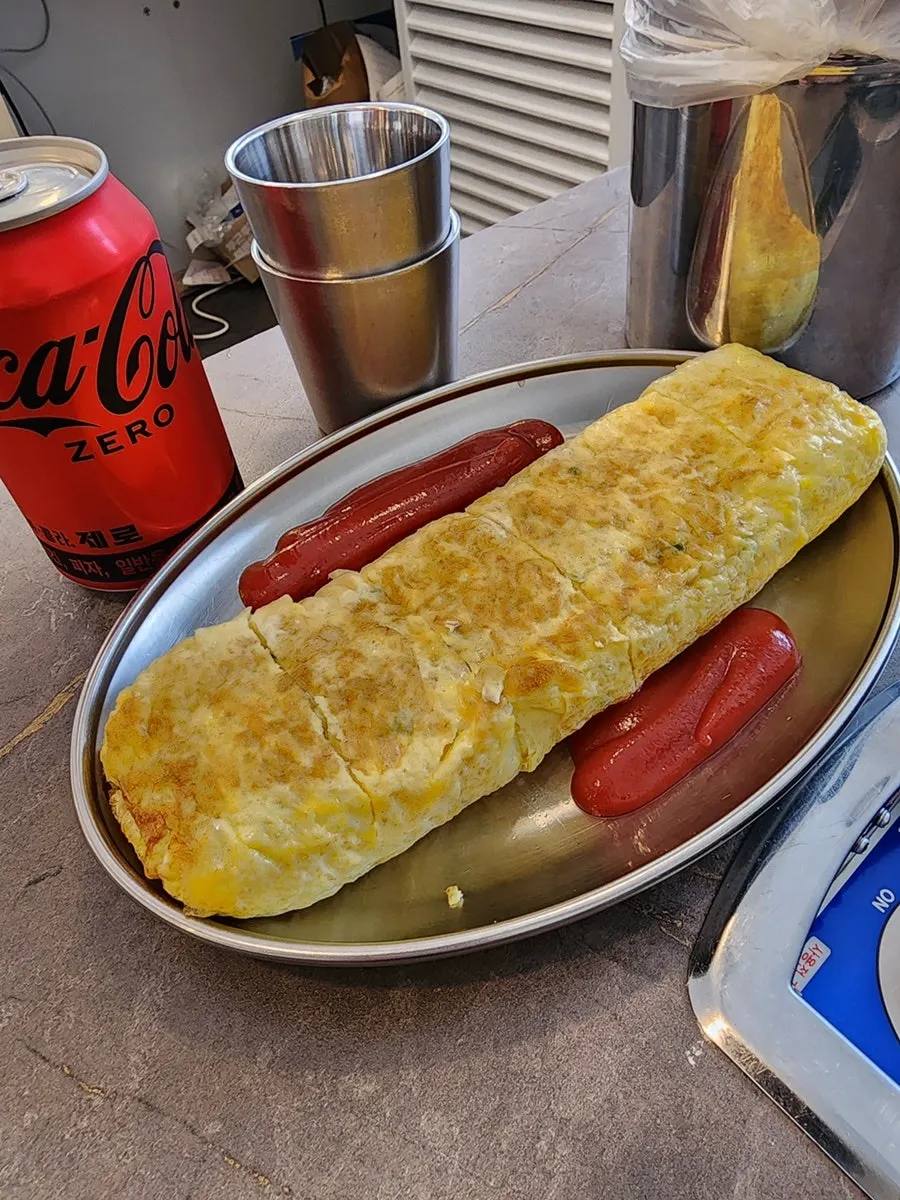 Thick egg roll served with ketchup on the side