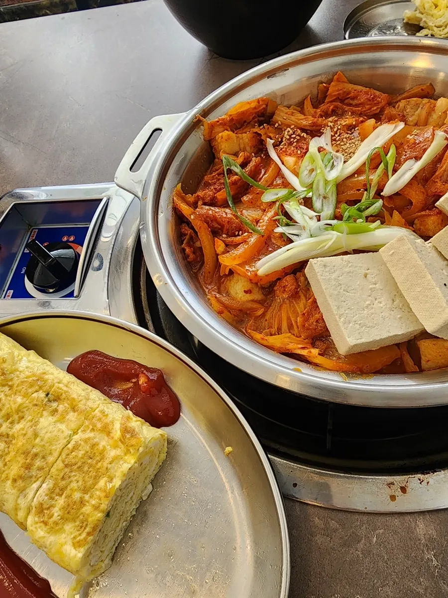 Pot of pork belly kimchi-jjim simmering on the burner
