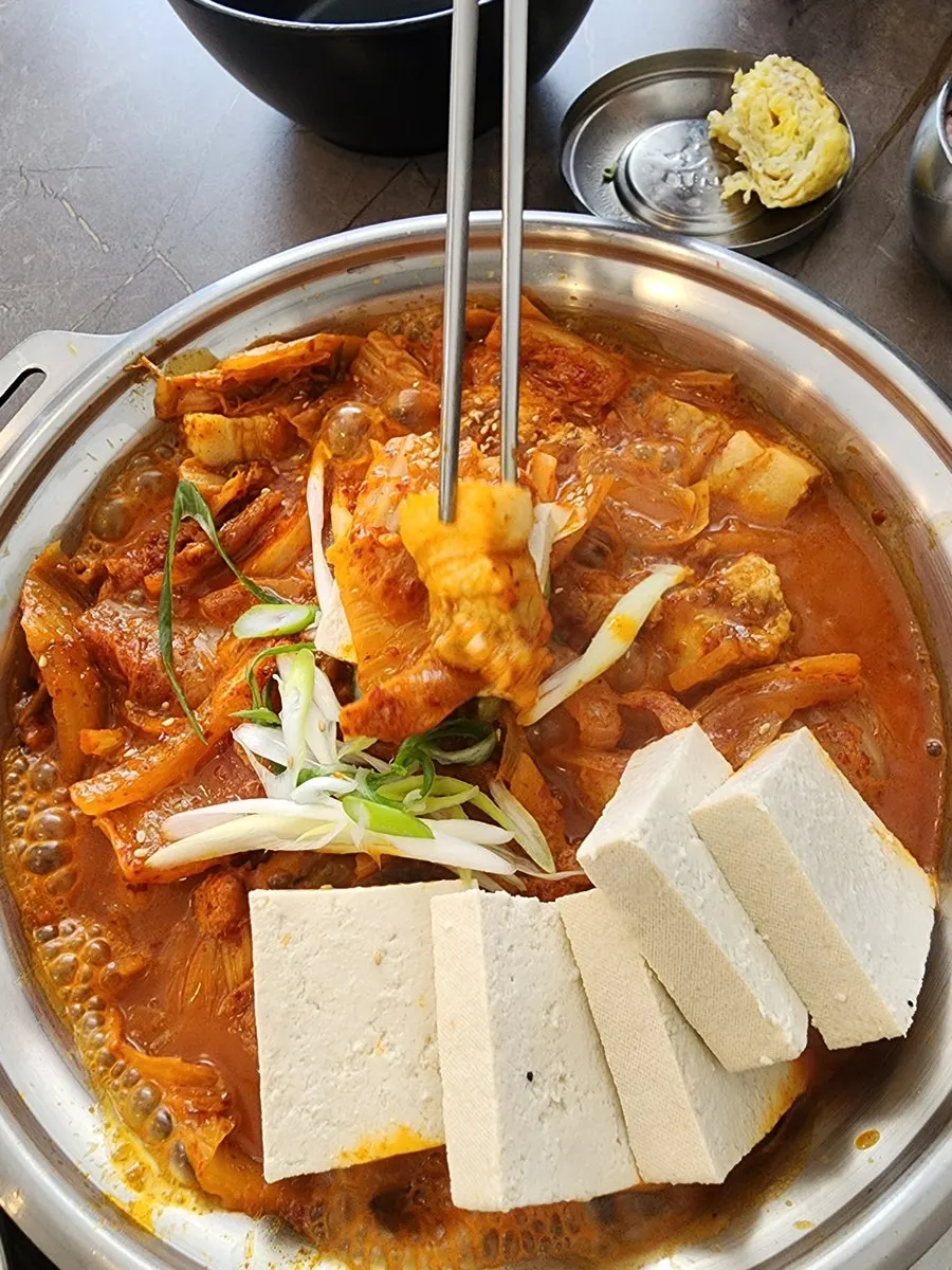 A wrapped bite of meat and kimchi
