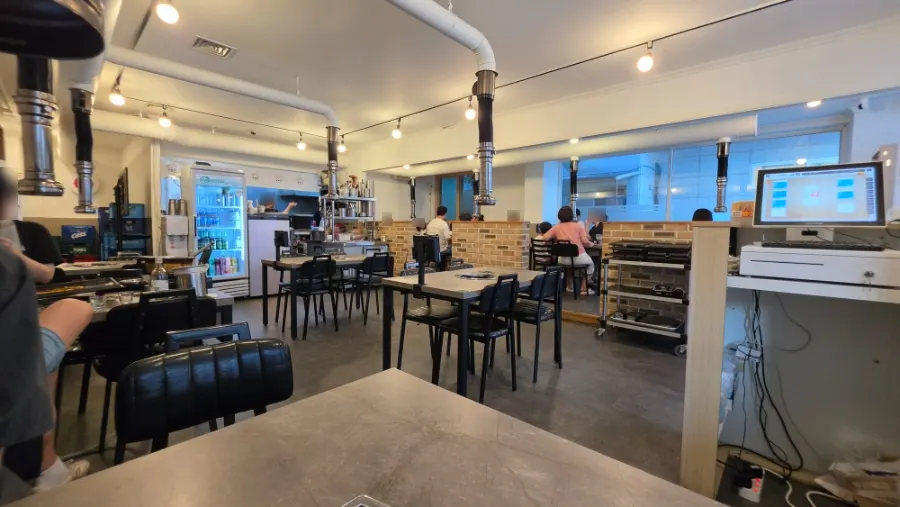 Busy restaurant interior with many customers seated
