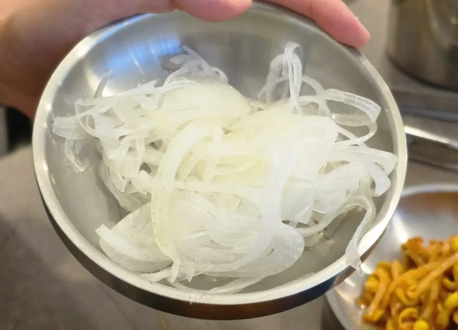 Plate of sliced onion and other side dishes