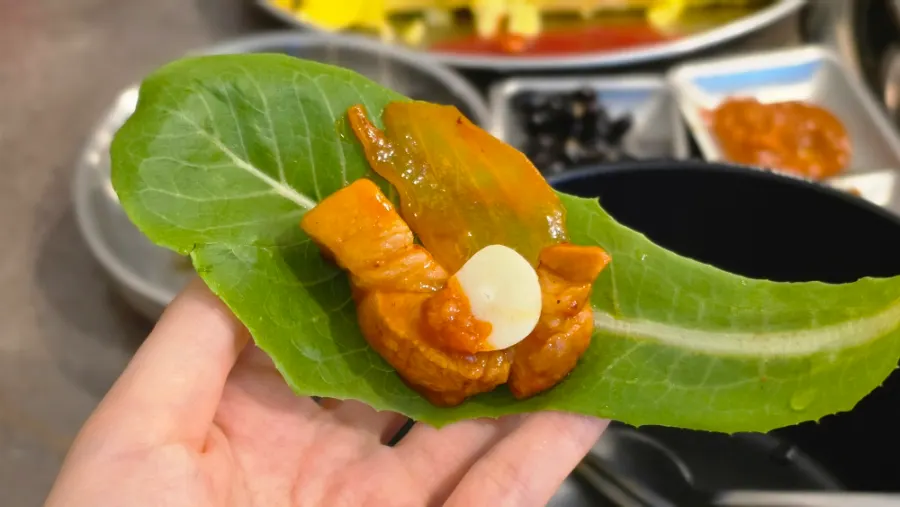 Raw garlic and meat placed on a wrap