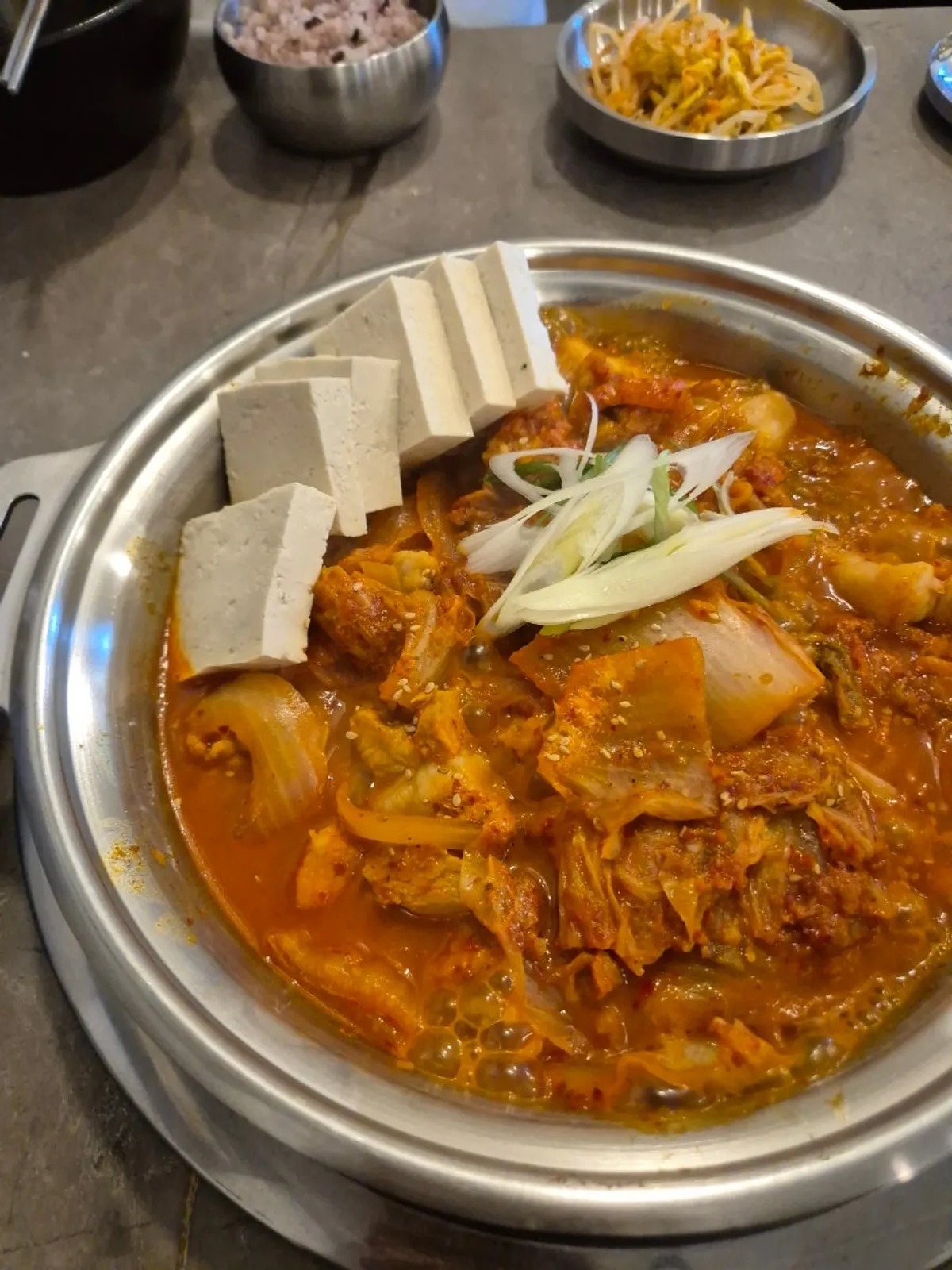 Full table spread of the samgyeop kimchi jjim set