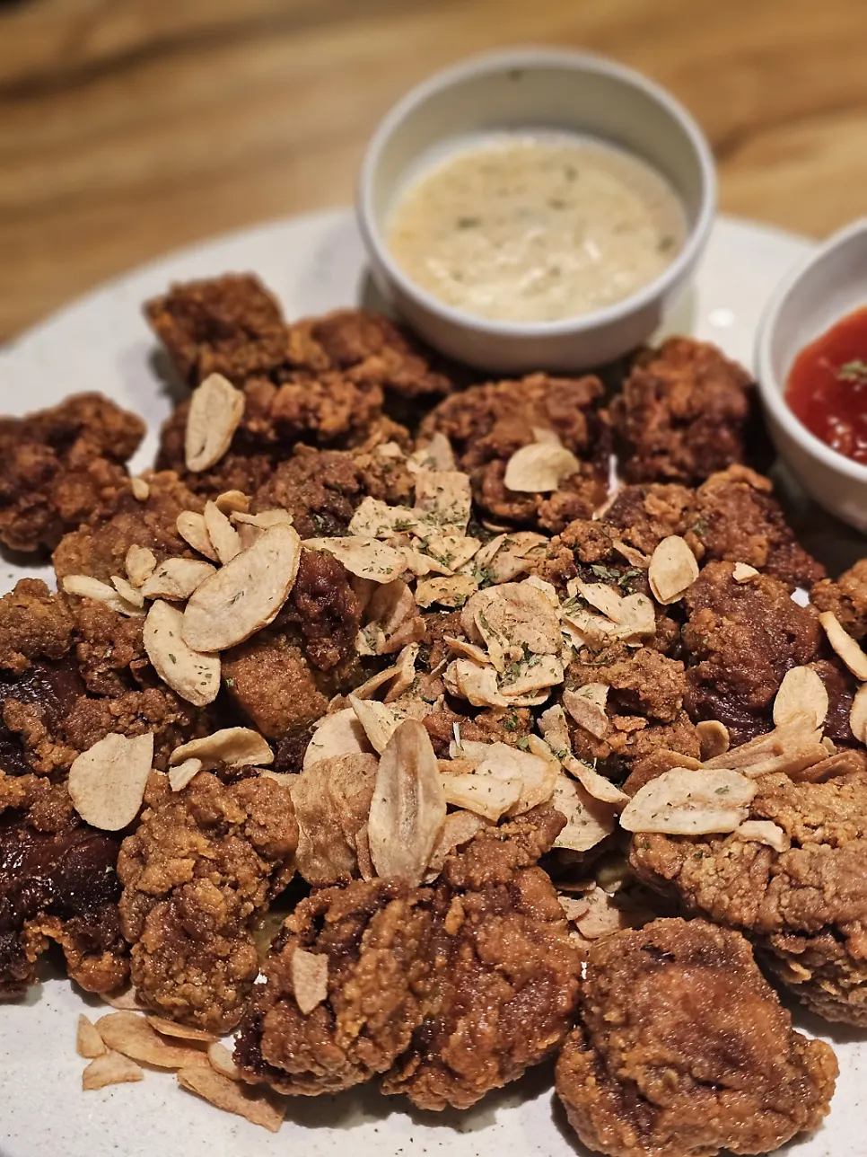 Garlic fried chicken gizzards topped with garlic chips