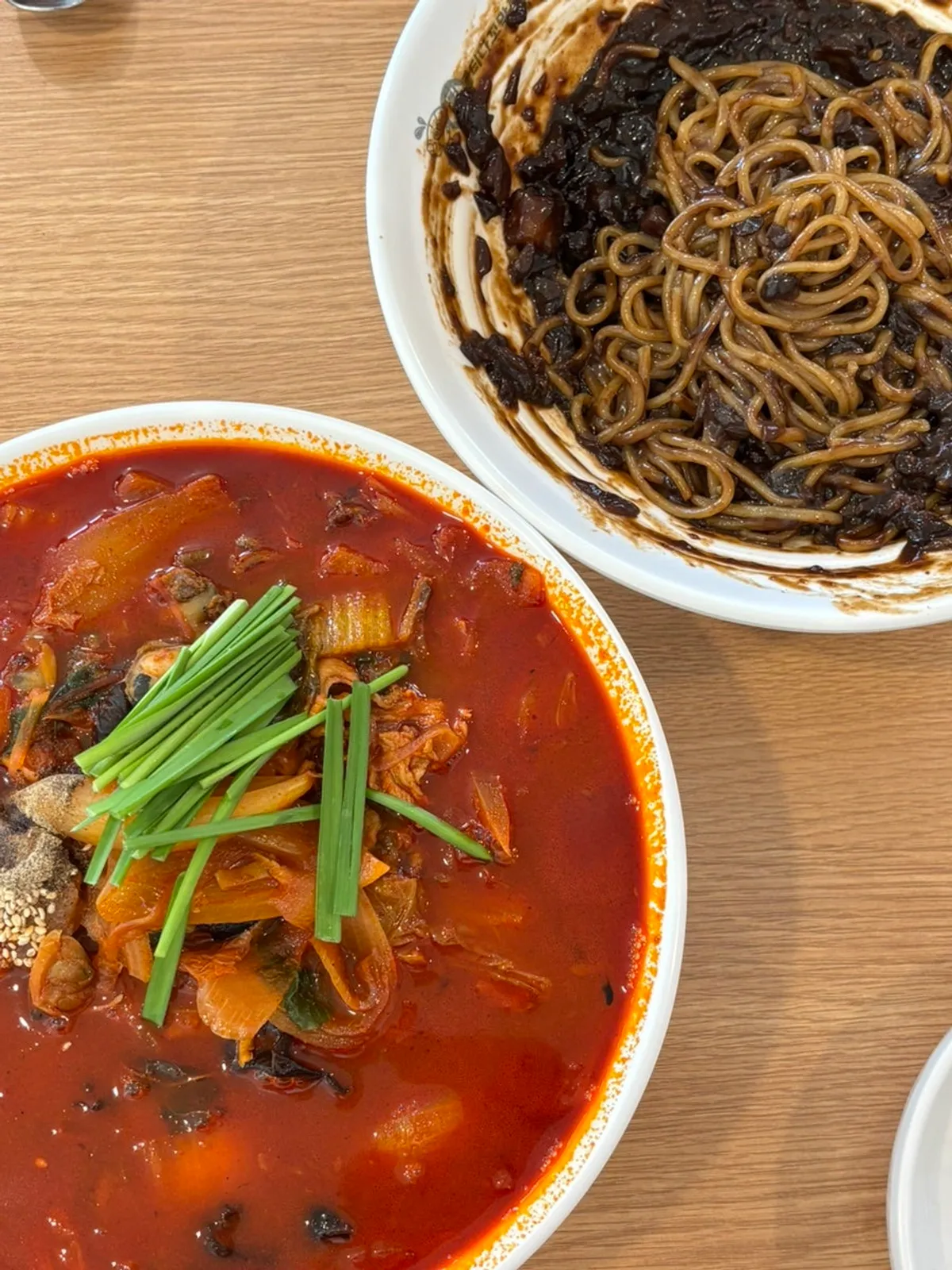 Full table spread of large cockle jjamppong and jajangmyeon
