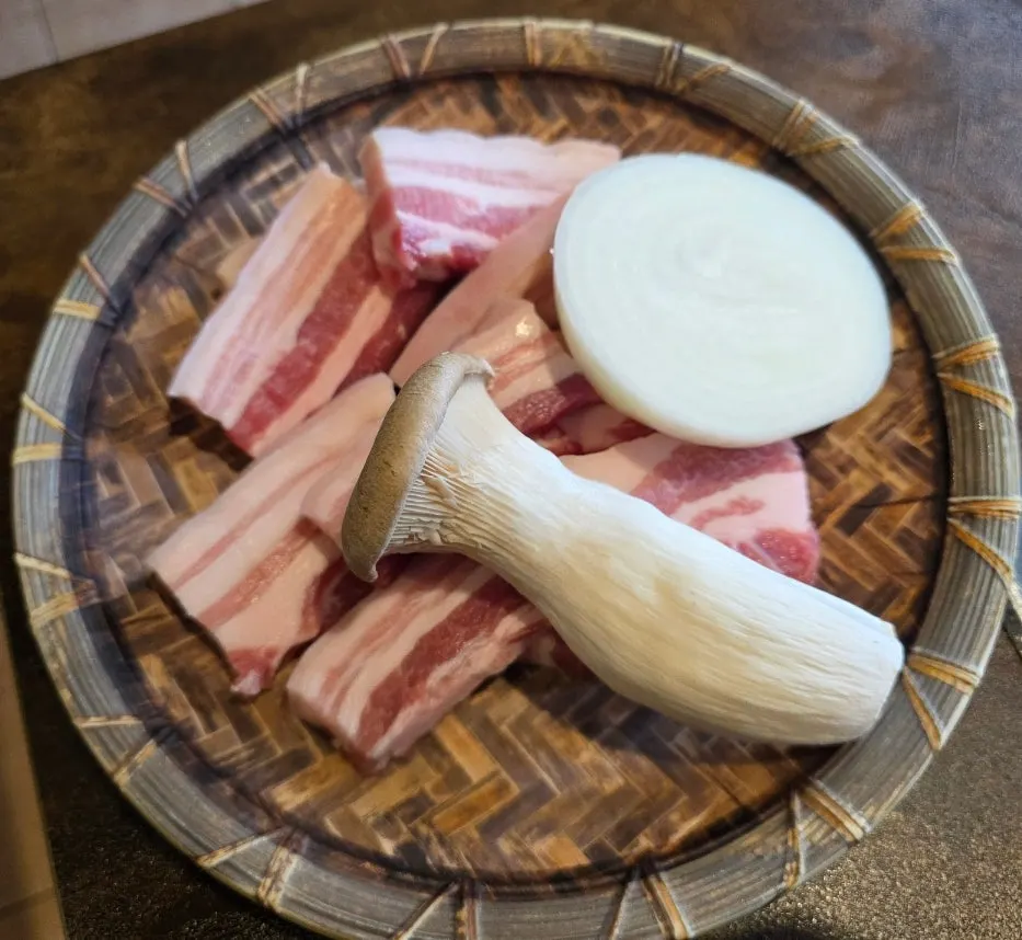 Thick-cut fresh pork belly served on the table