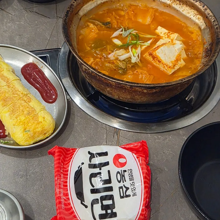 Ramyeon noodles added into the kimchi jjigae