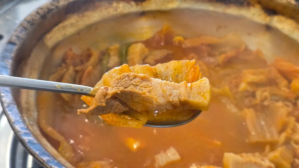 Thick, long-cut pork belly inside the kimchi jjigae