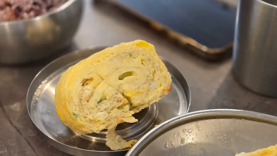 Thick egg roll served with ketchup