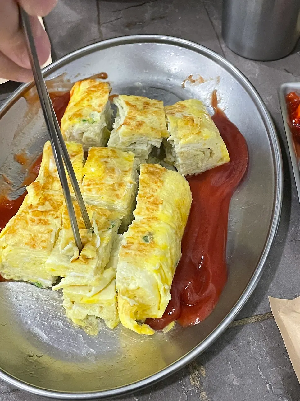 Plate with egg roll served alongside kimchi jjim