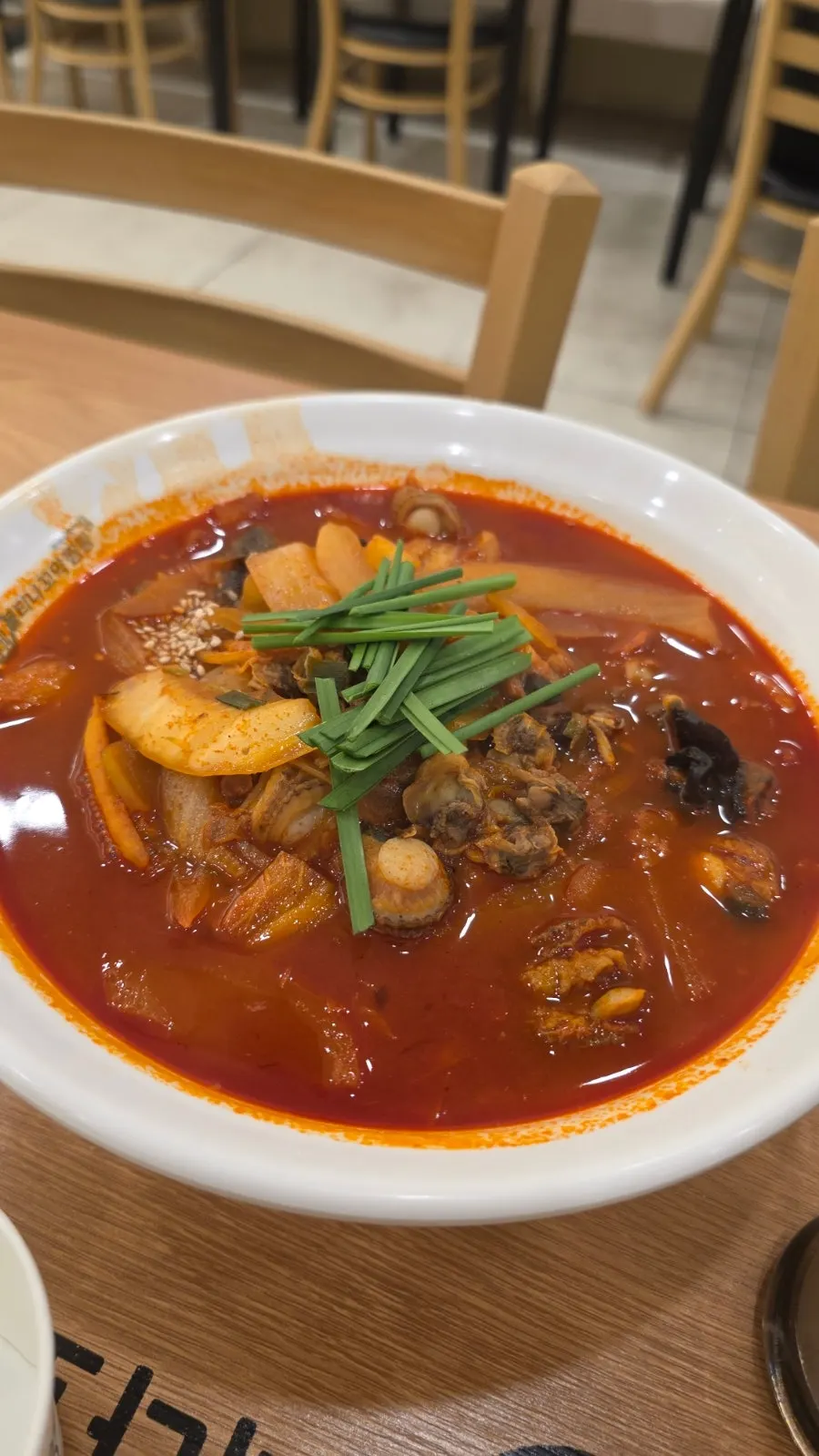 Warming spicy jjamppong generously filled with cockles
