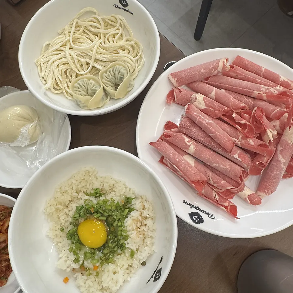 A shabu-shabu pot piled high with added toppings