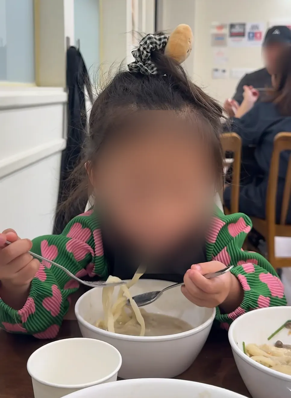 A bowl of kalguksu noodles and dumplings simmered in perilla broth