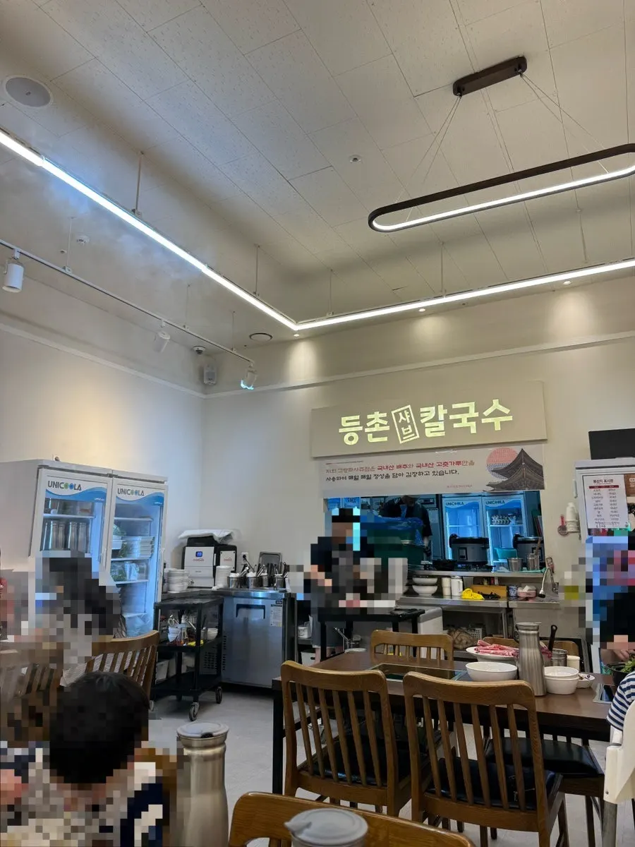 Interior of Deungchon Shabu Kalguksu Gran Passage Branch with plenty of tables