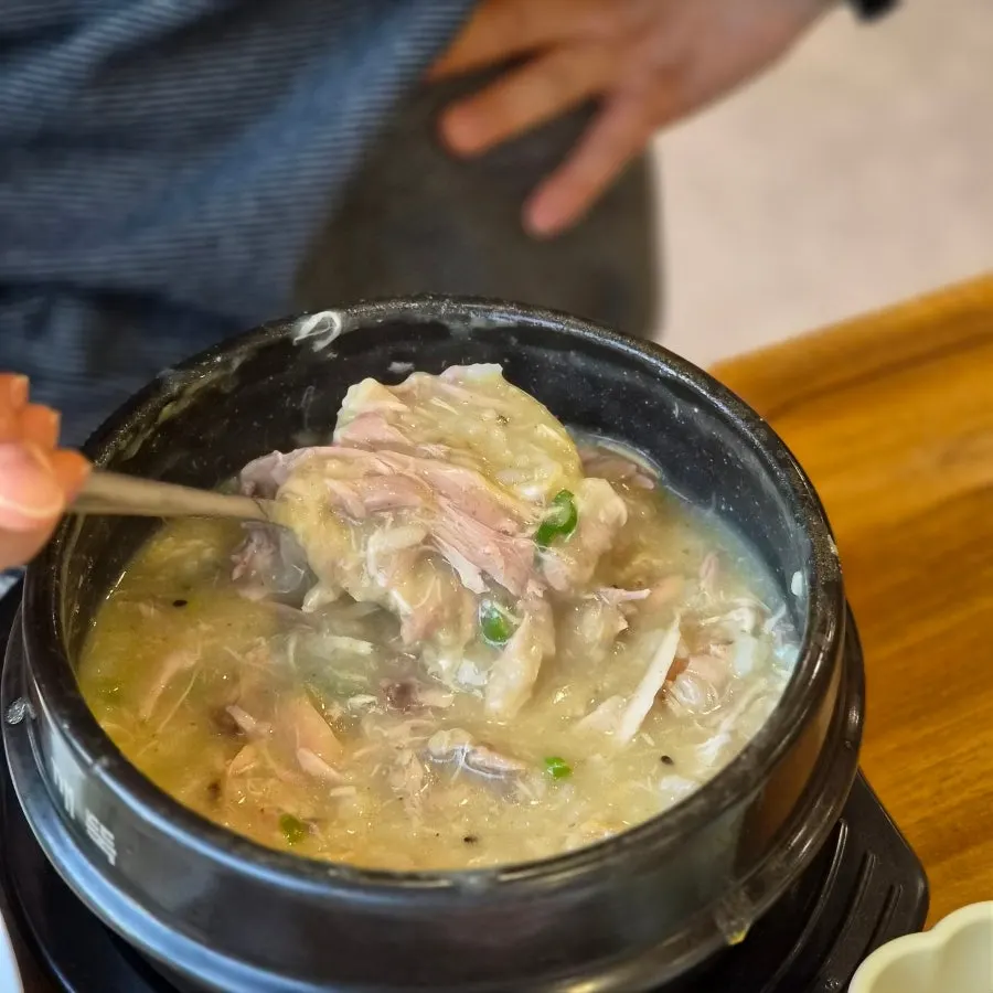 Table set for a samgyetang meal with a baby