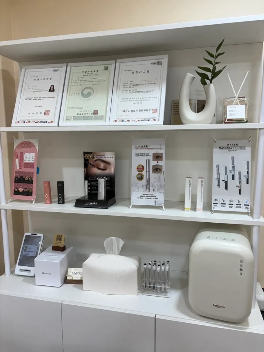 Cosmetologist license displayed on the wall
