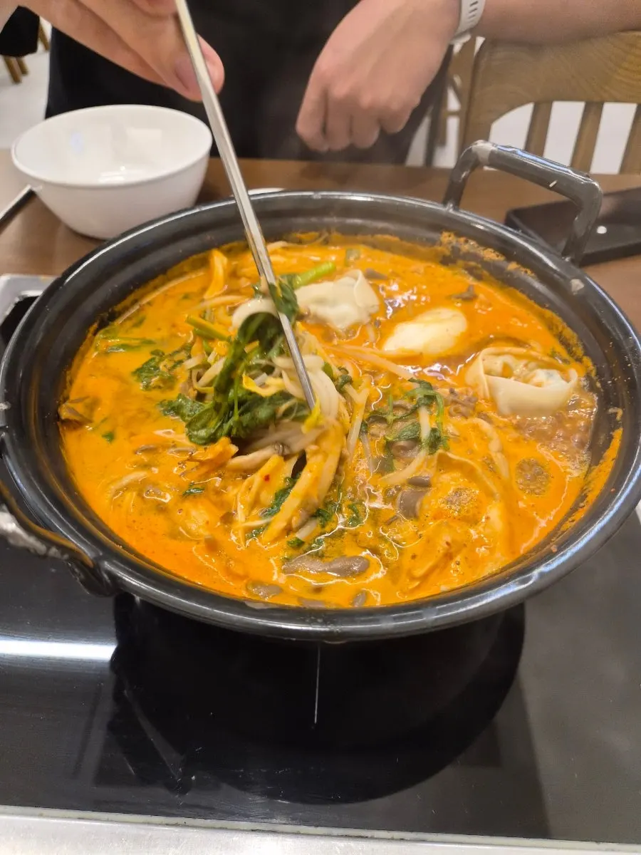 Spicy hot pot with beef and dumplings added