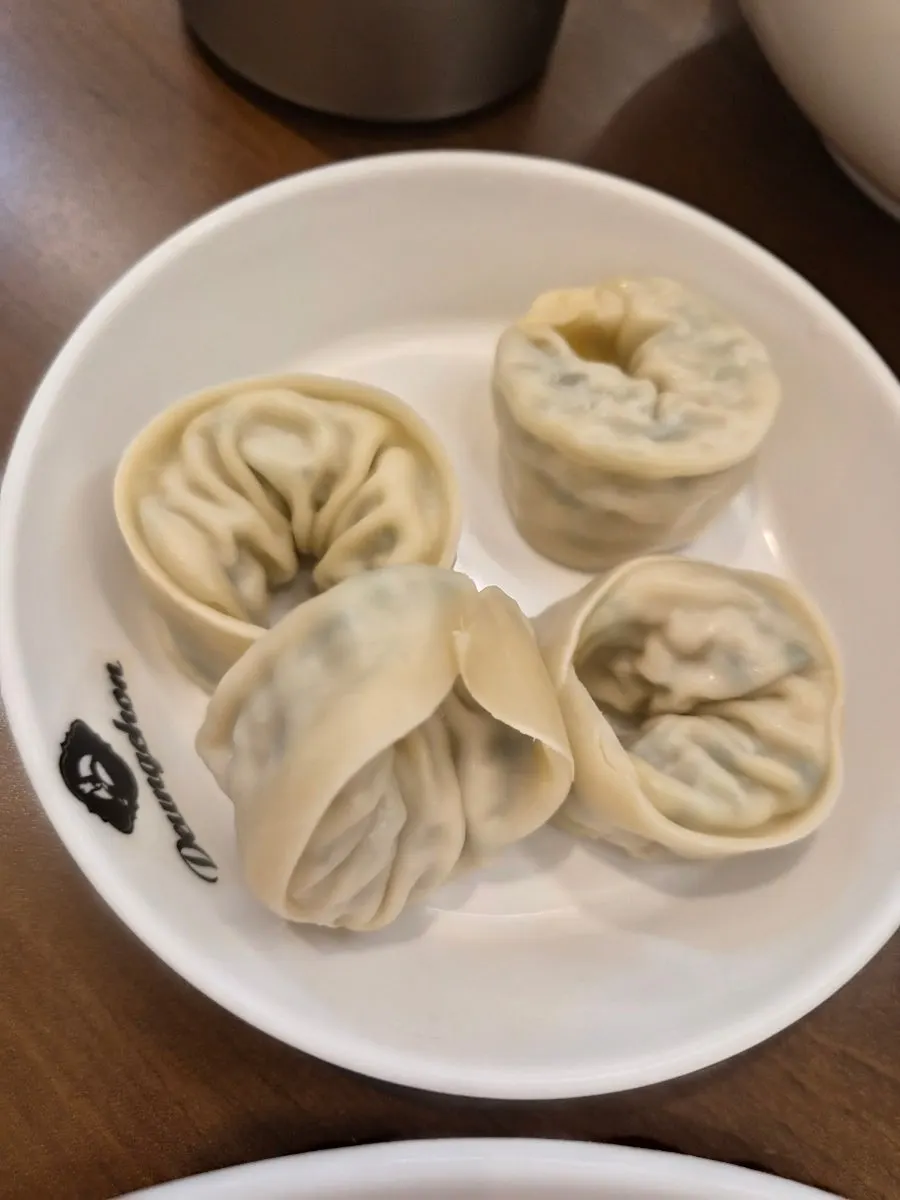 Scooping out minari and beef to eat