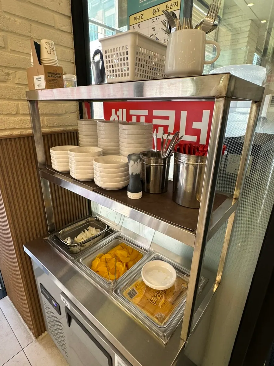 Self-serve corner where you can grab side dishes and utensils