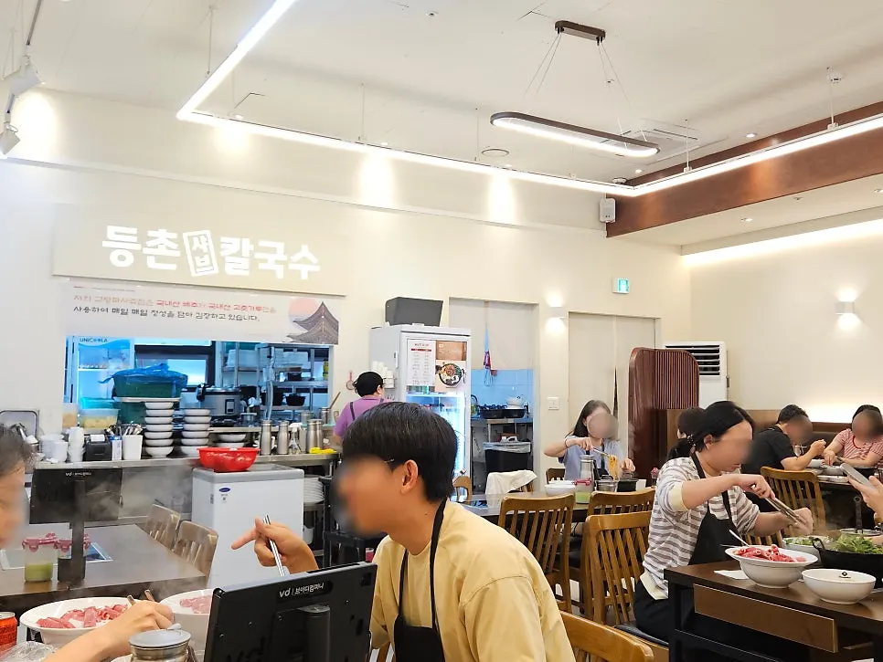 Interior of Deungchon Shabu Kalguksu busy with weekday lunch customers