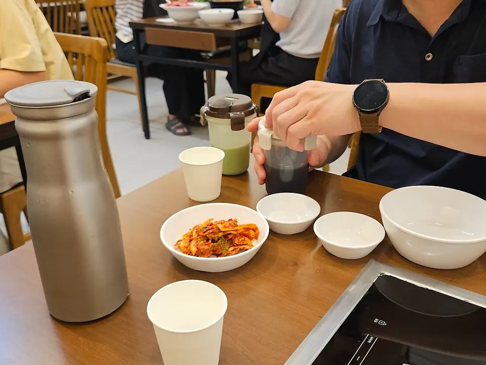 Basic table setting with small plates, soy sauce, wasabi, and kimchi
