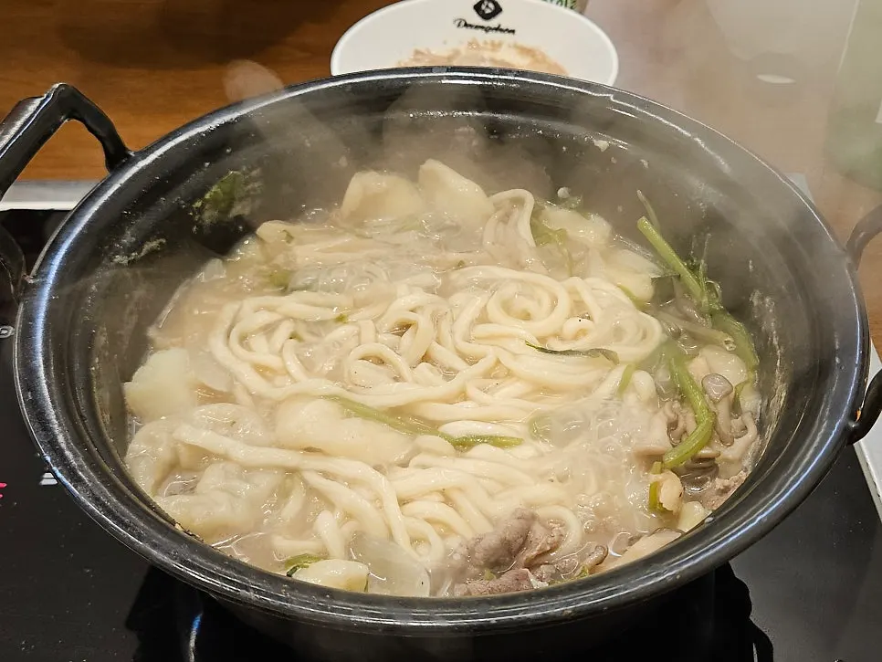 Kalguksu noodles added into the clear broth