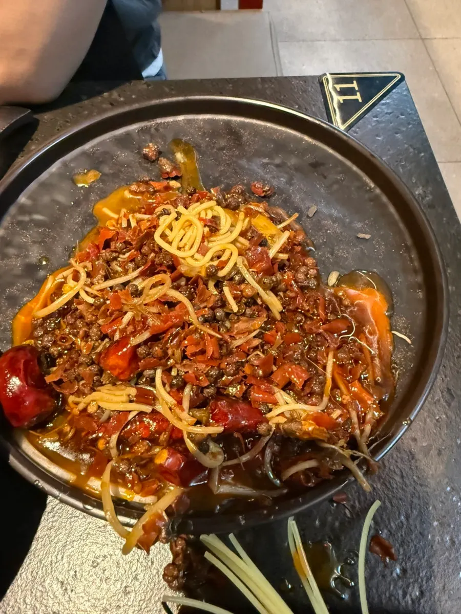 Ingredients added into the medium-spicy Chengdu red broth