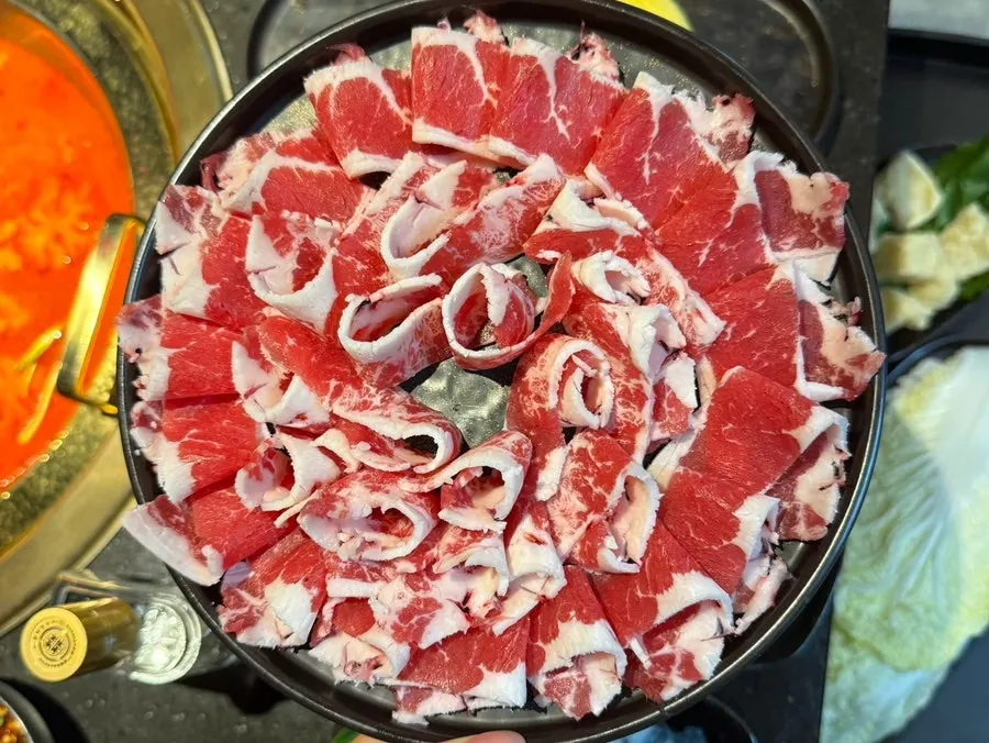 Half-and-half hotpot loaded generously with ingredients toward the end of the meal