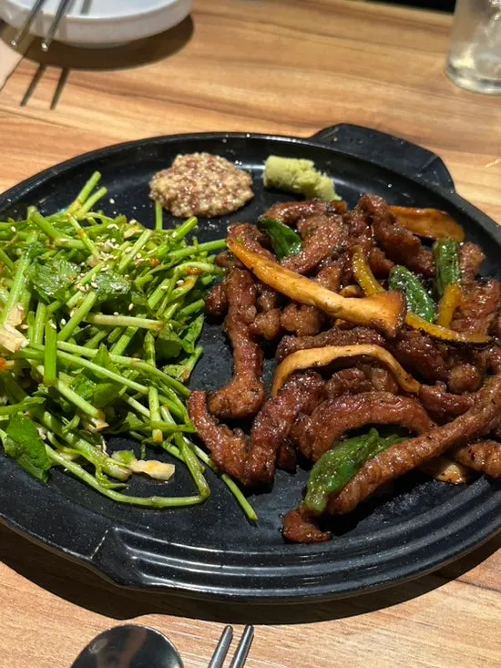 Iberico pork jowl grill served with sauce and vegetables