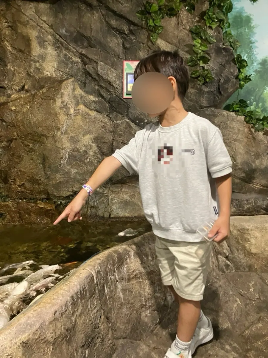 Feeding a carp gulping with its mouth open