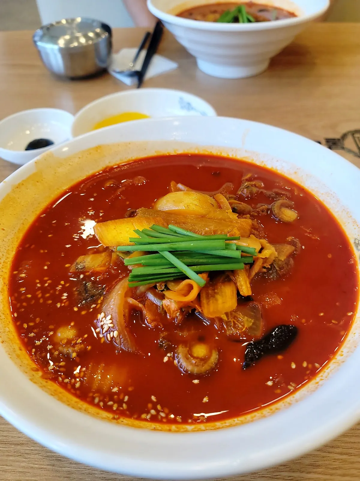 A bowl of cockle jjamppong with red broth