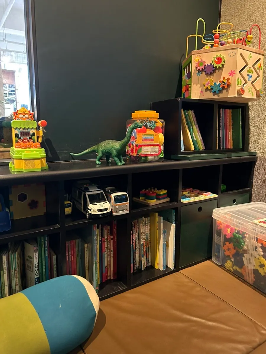 A corner of the kids room with a large TV