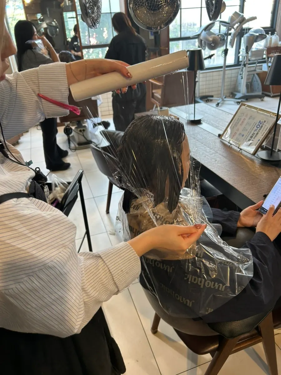 Volume magic solution being applied to short hair