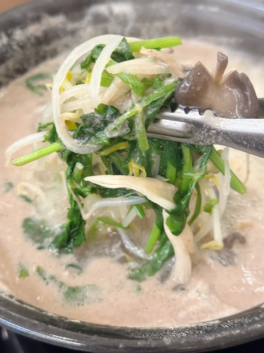 Clear mushroom kalguksu served in a bowl
