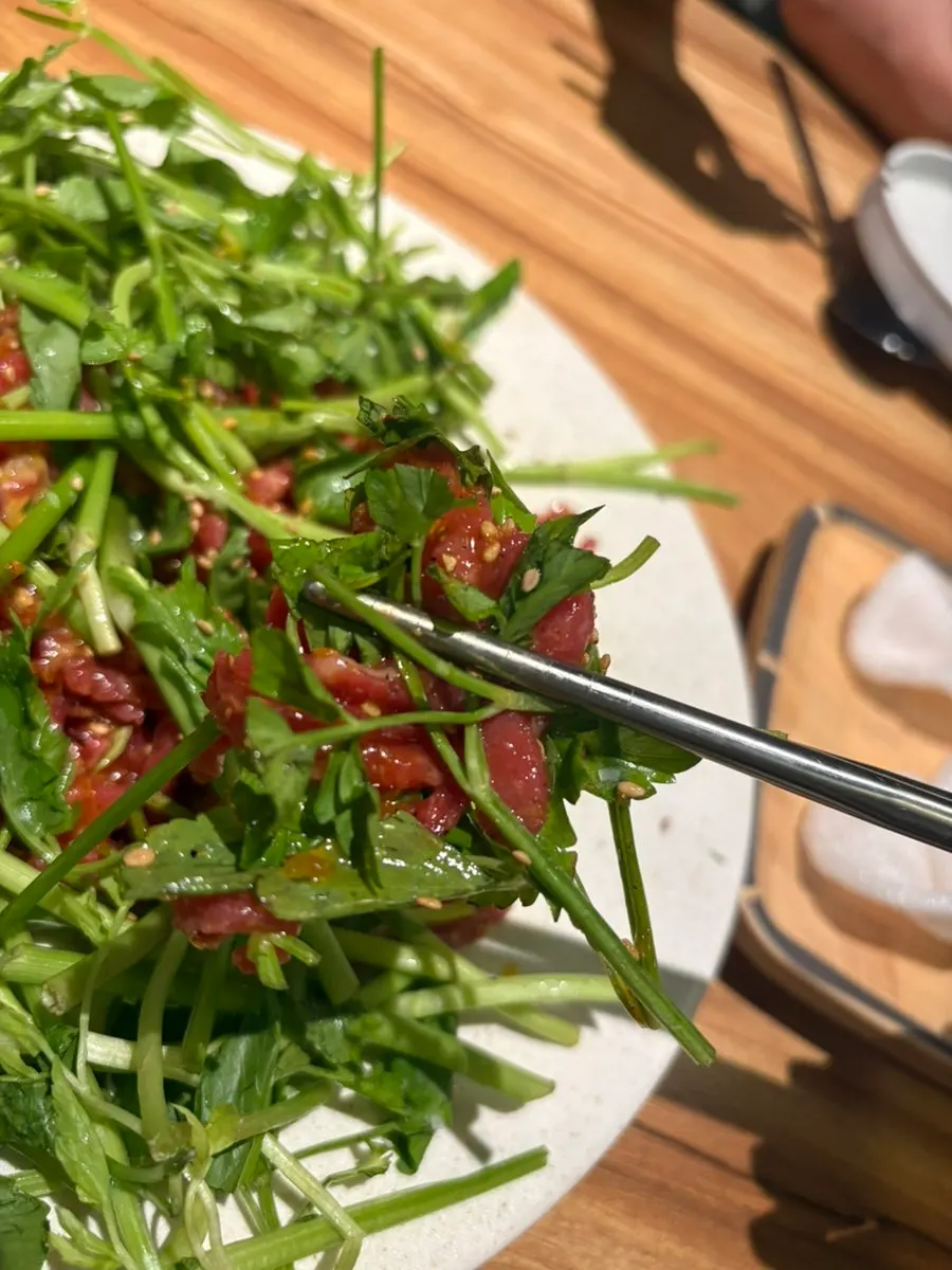 Close-up of hanwoo beef tartare topped with minari