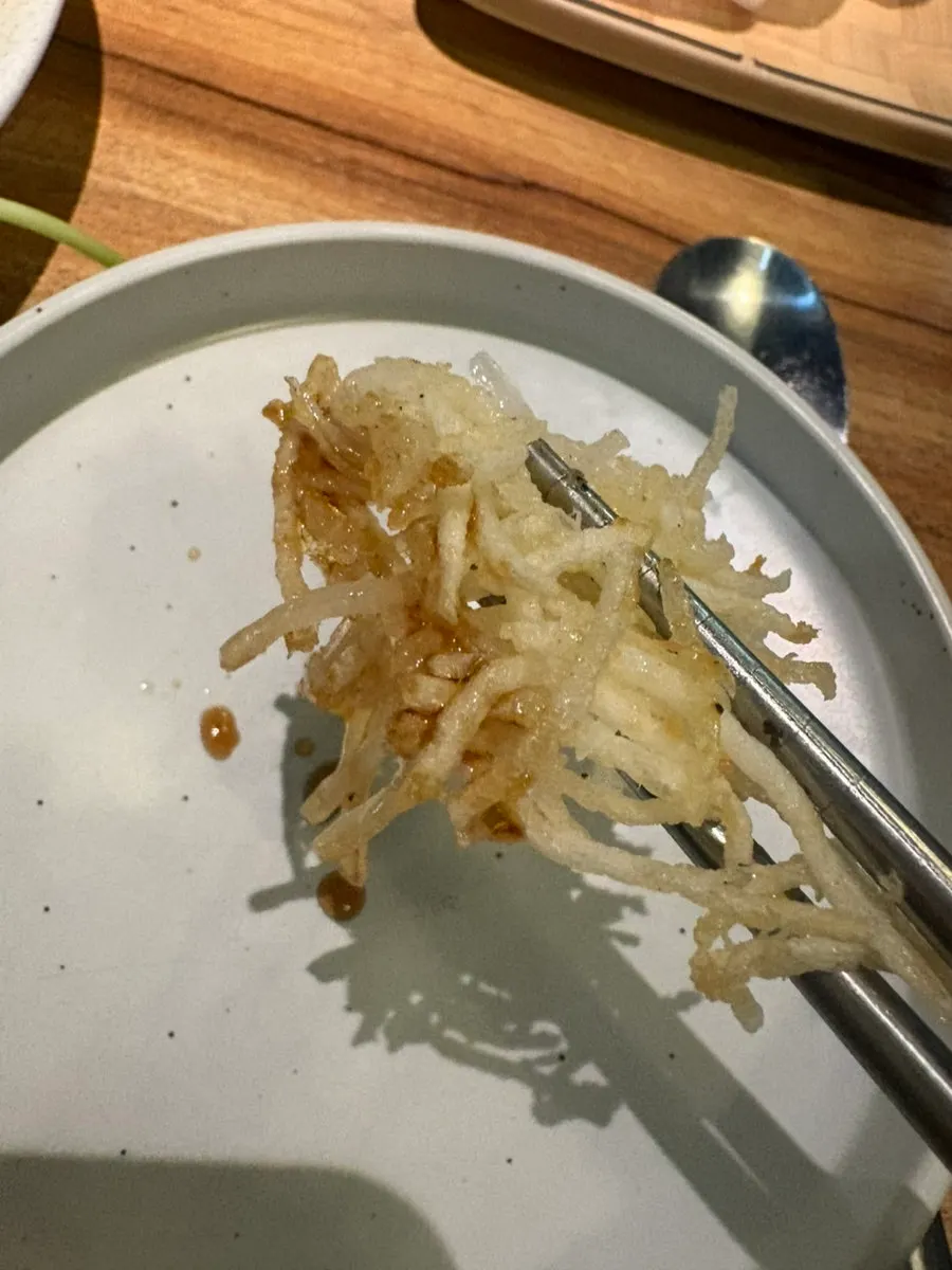 Thin sillsatarae gamjajeon showing its shredded potato texture
