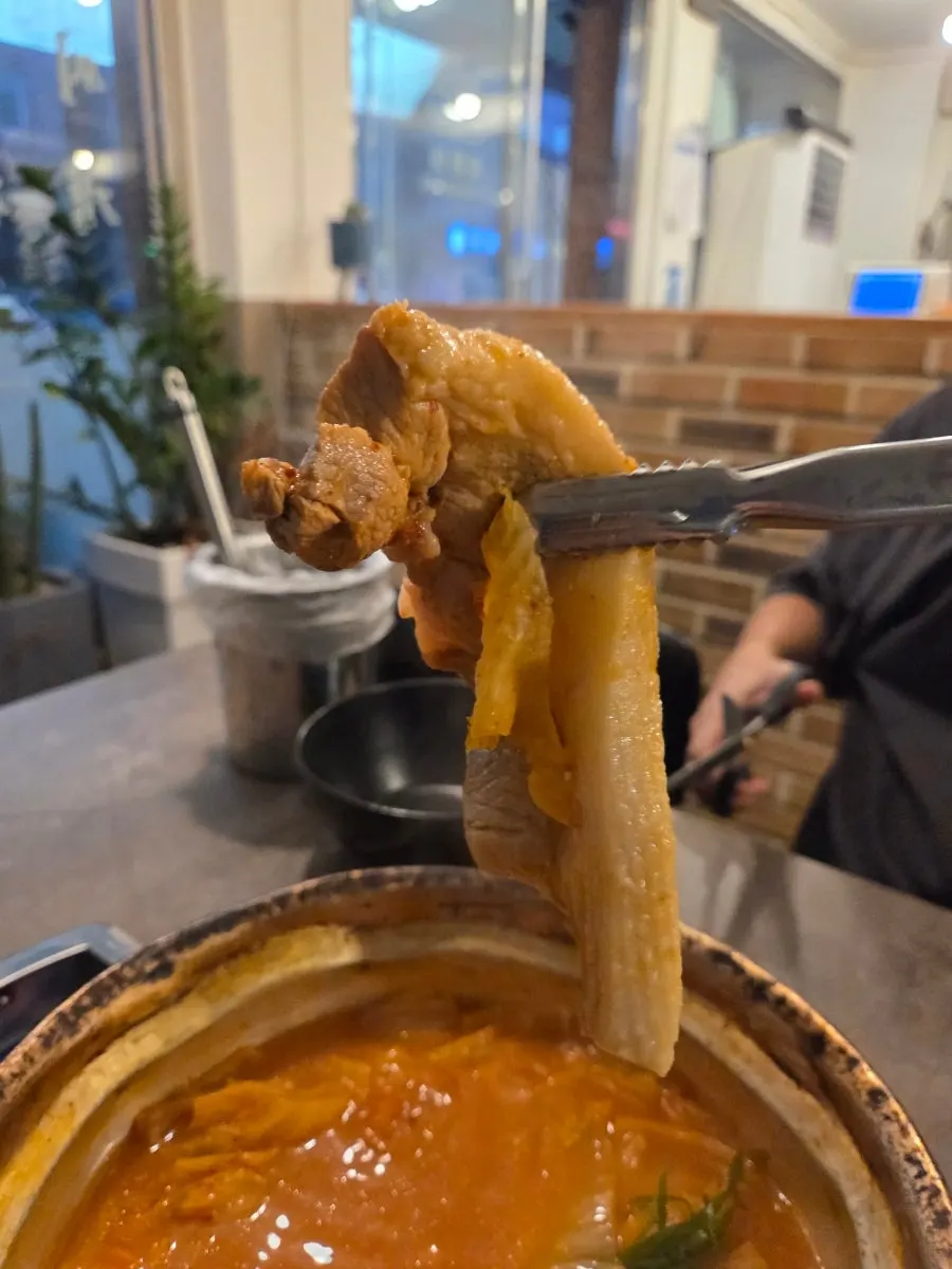 Cutting the whole chunk of pork with scissors