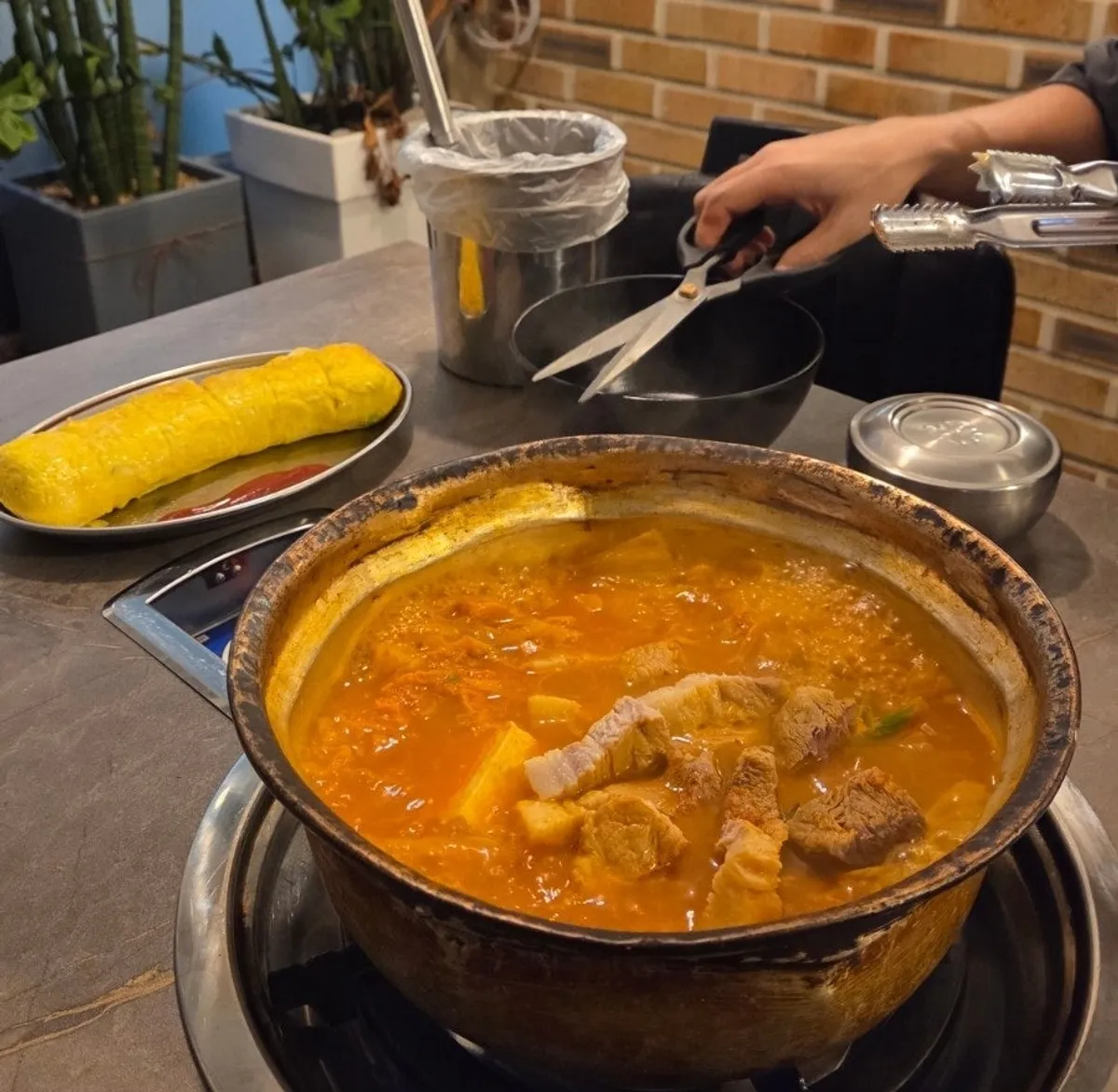 The pot of kimchi jjigae just starting to bubble