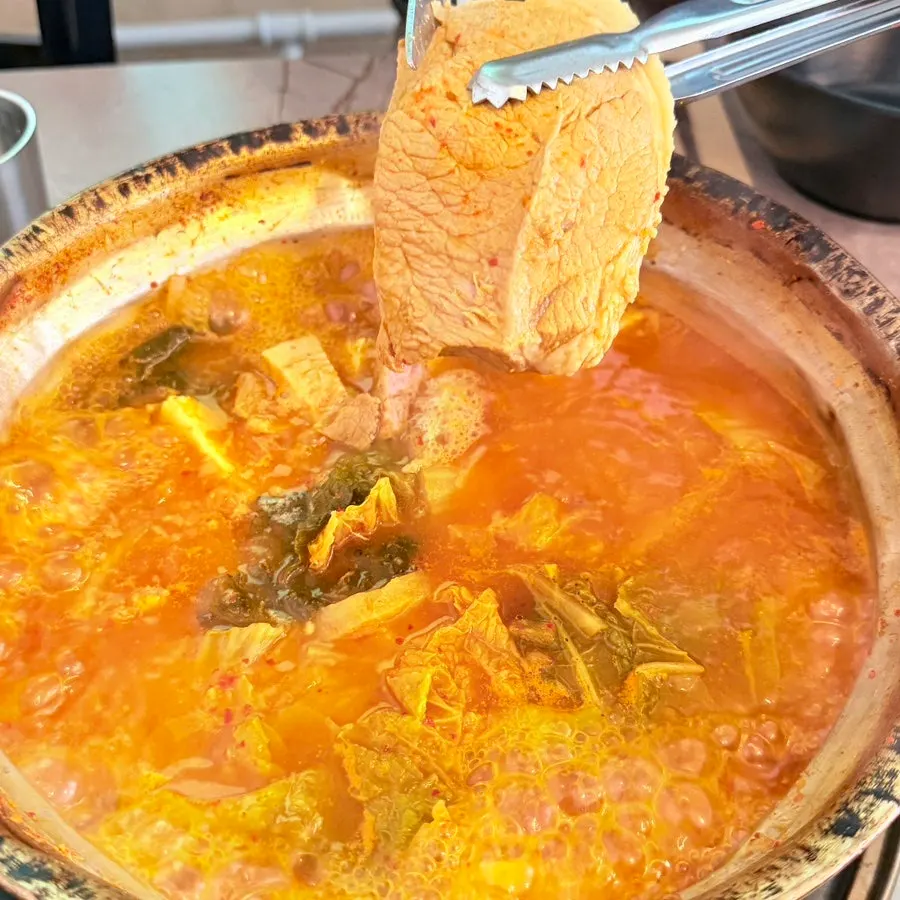 Large chunks of meat and extra tofu in kimchi jjigae
