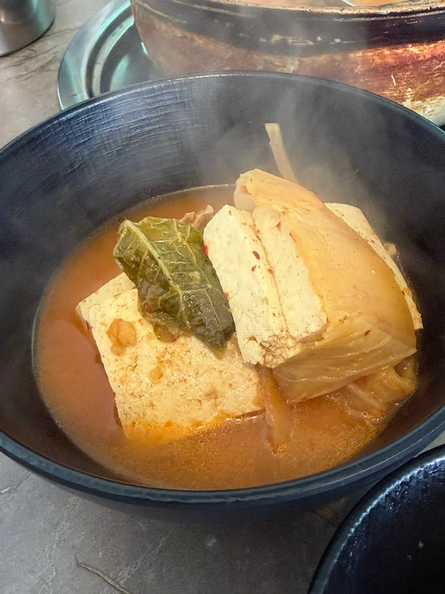 Kimchi jjigae ladled into an individual bowl