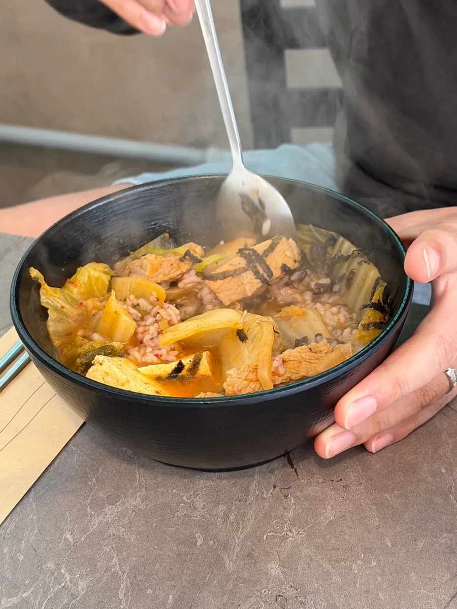 Kimchi jjigae with rice and seaweed flakes