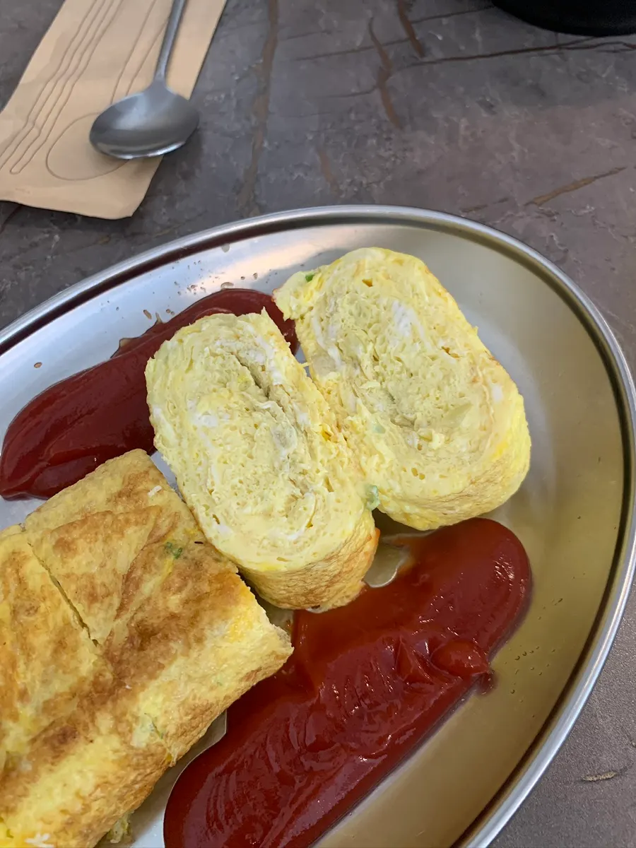 Hand comparison shot showing the enormous egg roll