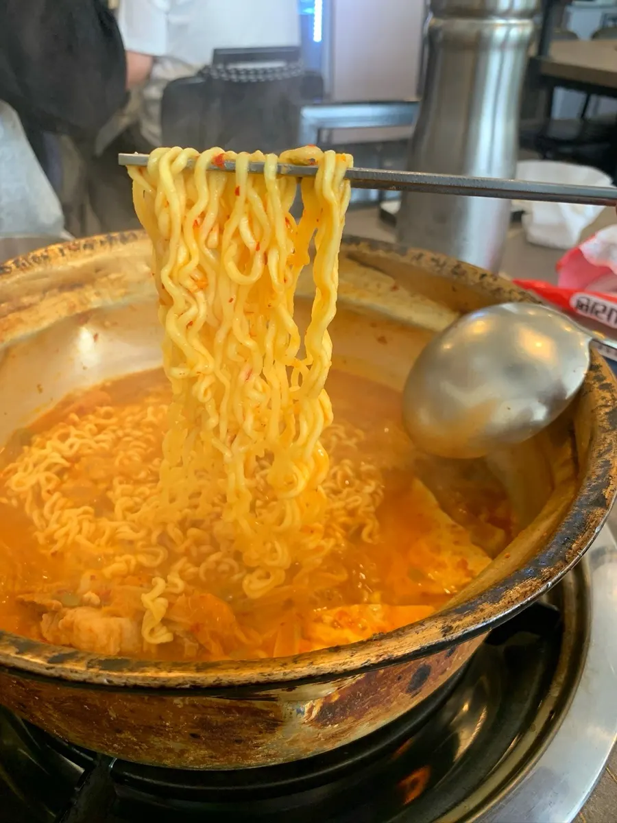 Ramyeon noodle add-on simmered in the kimchi jjigae broth