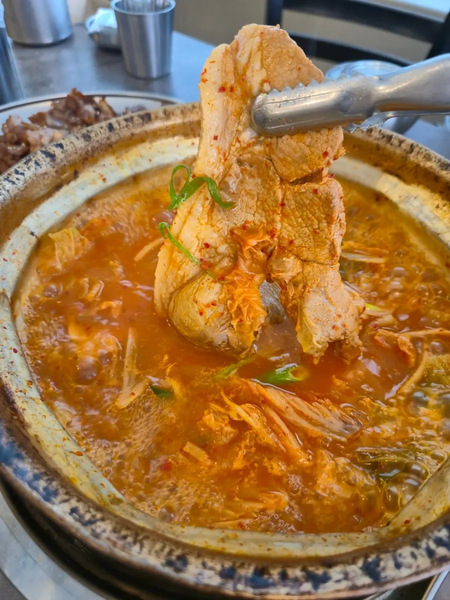 Pork and tofu simmering in the kimchi jjigae