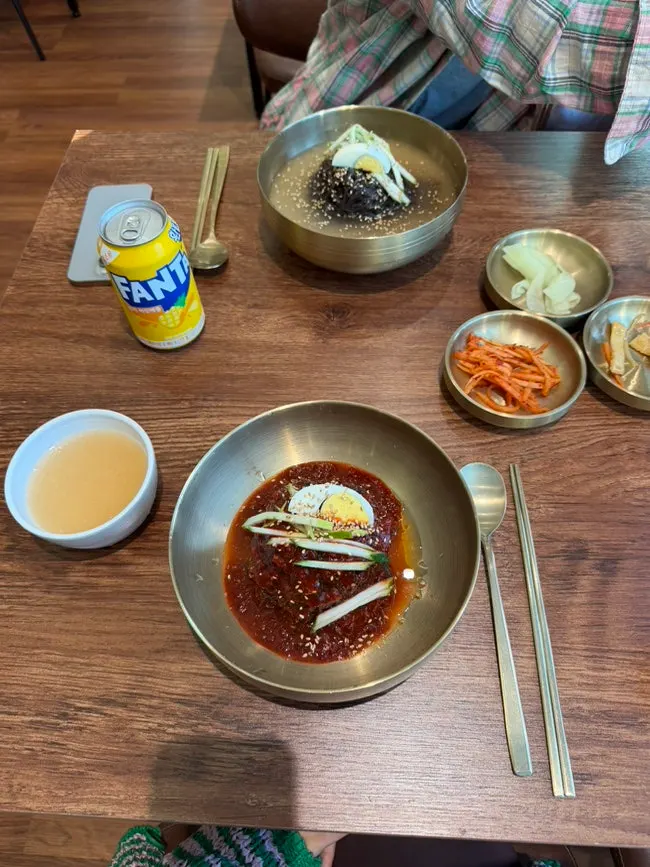Two bowls of bibim kudzu naengmyeon and cold broth kudzu naengmyeon