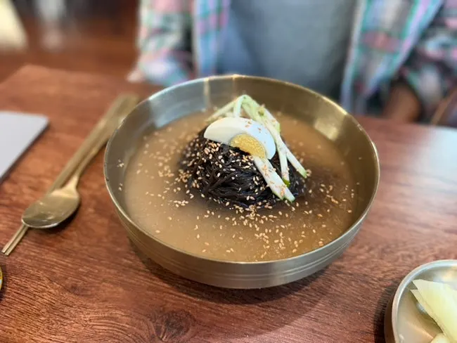 Kudzu naengmyeon topped with cucumber, radish, and egg
