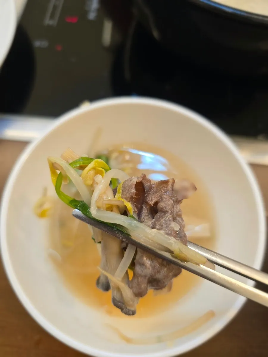 Mushroom shabu-shabu pot generously filled with mushrooms and minari