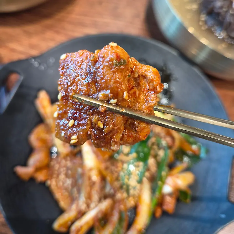 Table set with galbitang, naengmyeon, and gochujang pork belly together