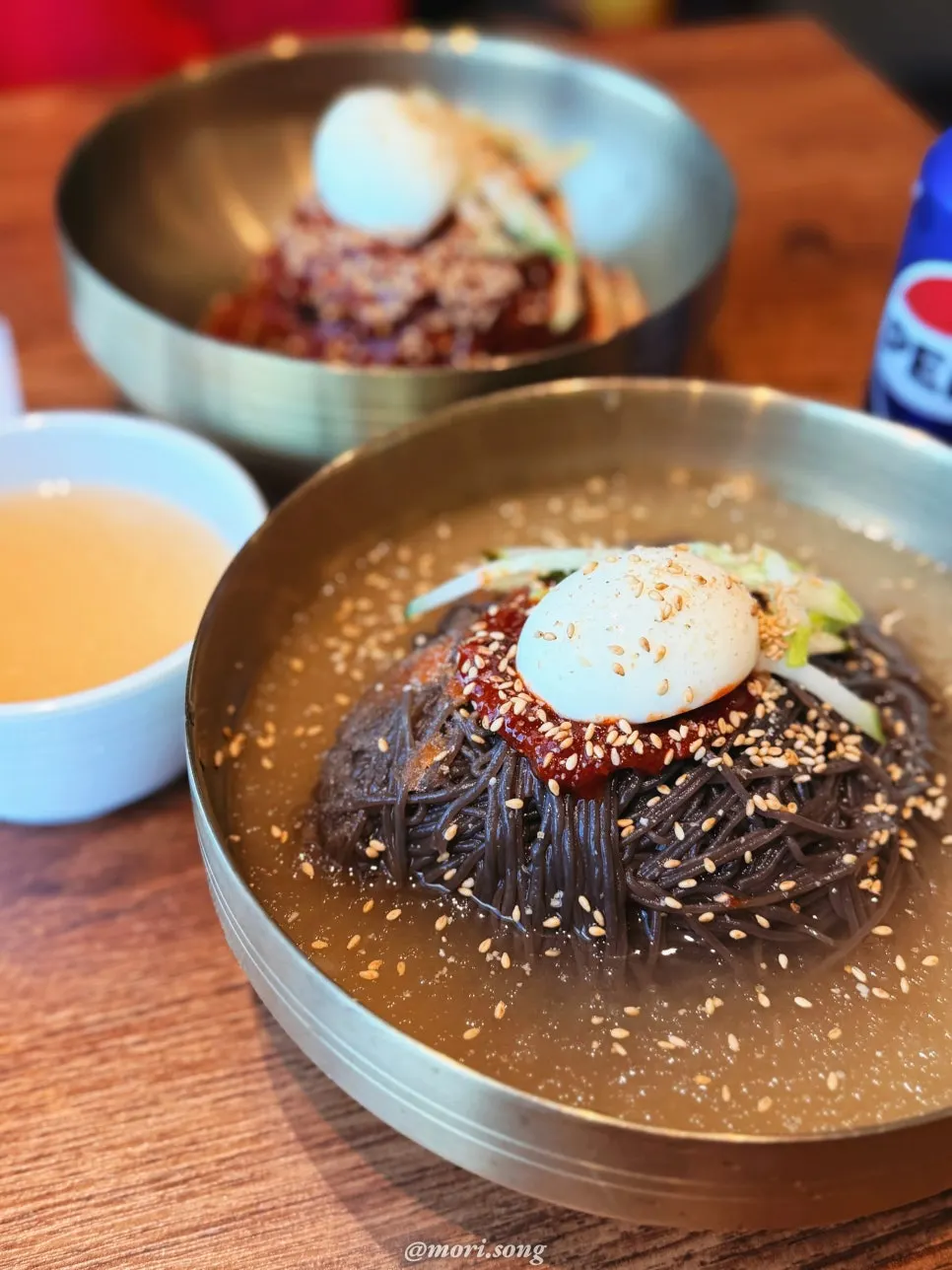 Table setting with naengmyeon and soy-marinated pork belly set
