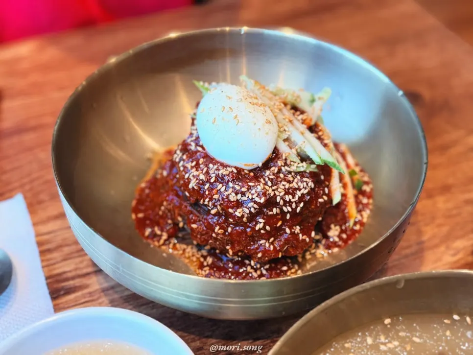 Bibim-naengmyeon topped with a generous amount of red sauce